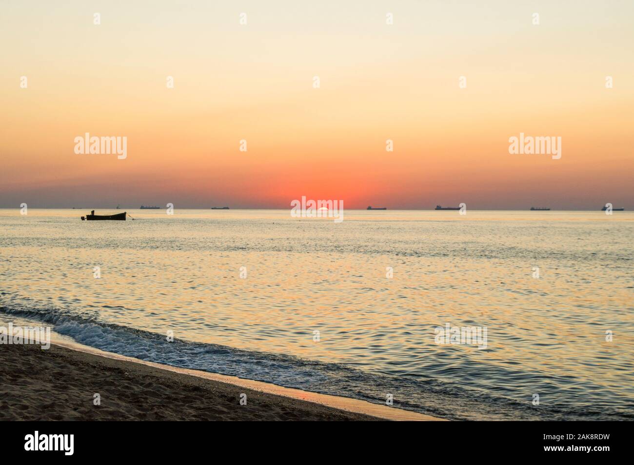 Beautiful sunrise on the sea shore on sandy beach Stock Photo - Alamy