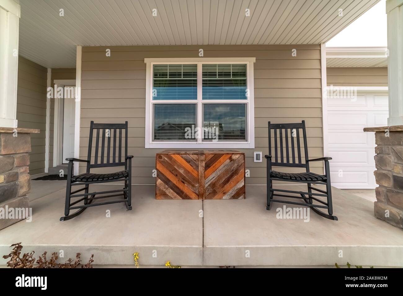 Two rocking chairs on a covered patio Stock Photo Alamy