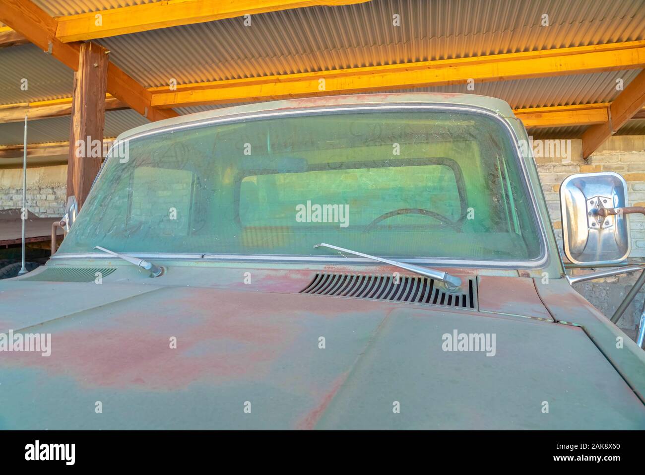 Close up front view of an old vintage car with dirty and rusty exterior ...