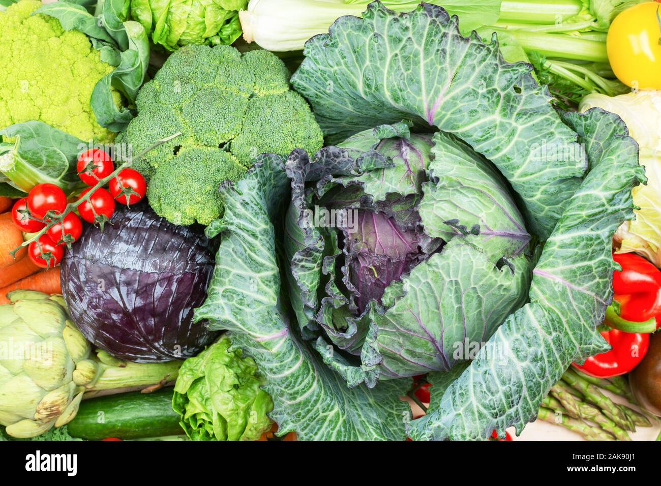 Top view of vegetables on wooden table, carrots velery tomatoes cabbage broccoli, copy space, selective focus Stock Photo