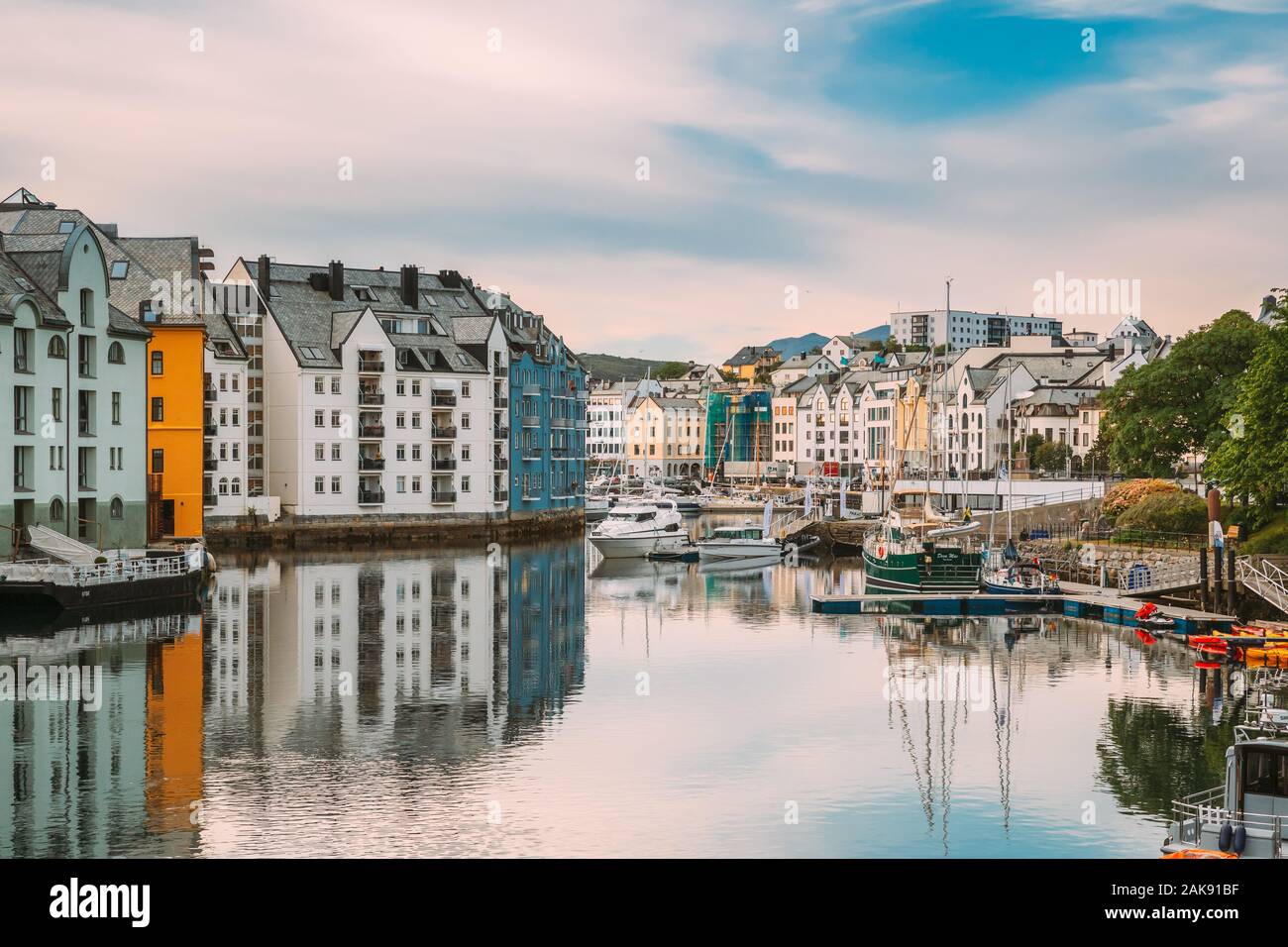 Alesund, Norway - June 19, 2019: Old Wooden Houses In Cloudy Summer Day. Art Nouveau Architecture Is Historic Heritage And Landmark. Stock Photo