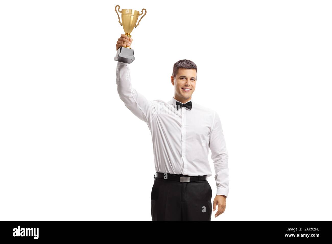 Full length portrait of a young man in a tux holding a golden trophy isolated on white background Stock Photo