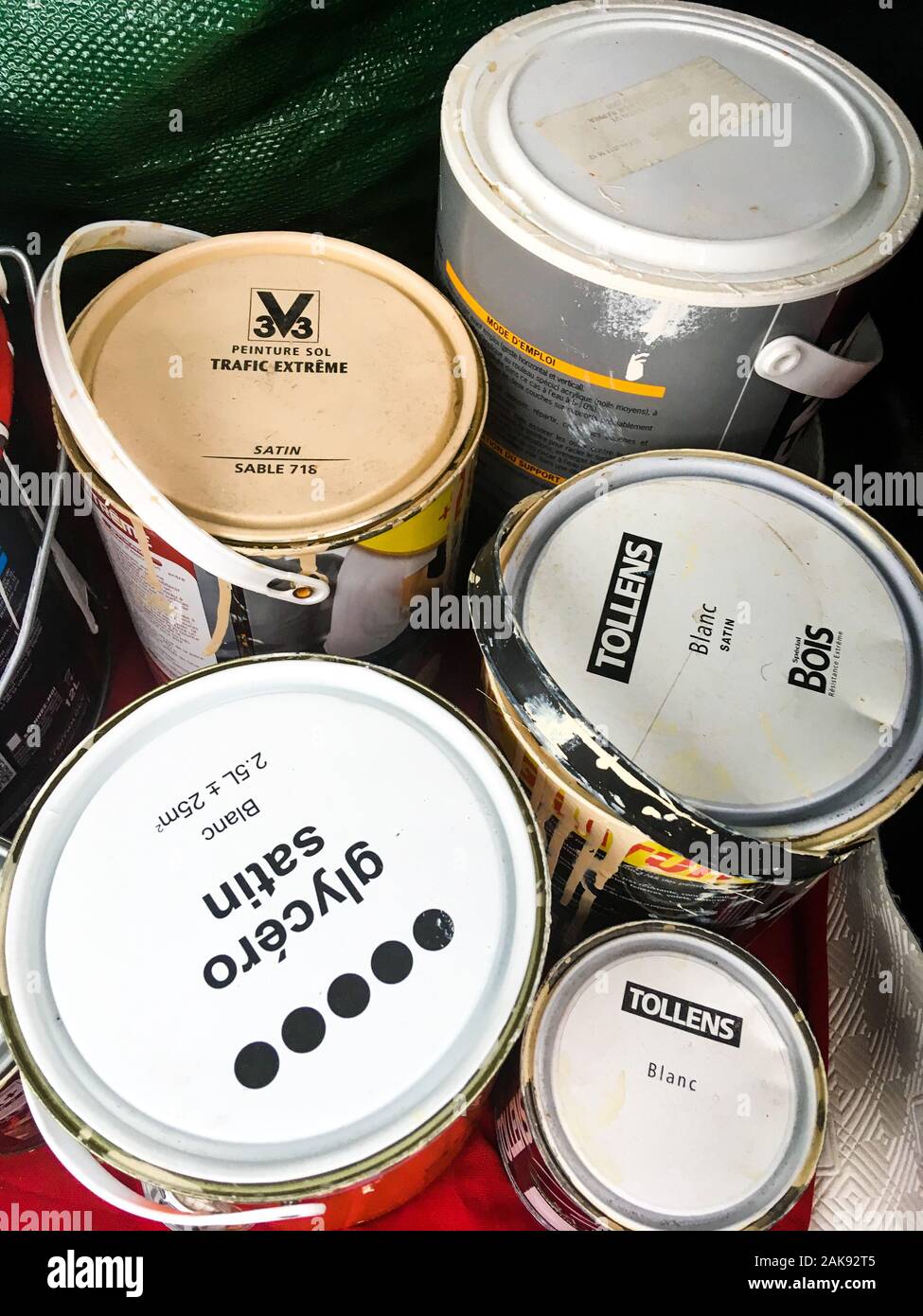 Paint buckets to recycle, stocked in a car trunk, Lyon, France Stock Photo