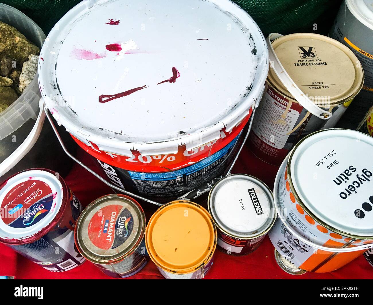 Paint buckets to recycle, stocked in a car trunk, Lyon, France Stock Photo