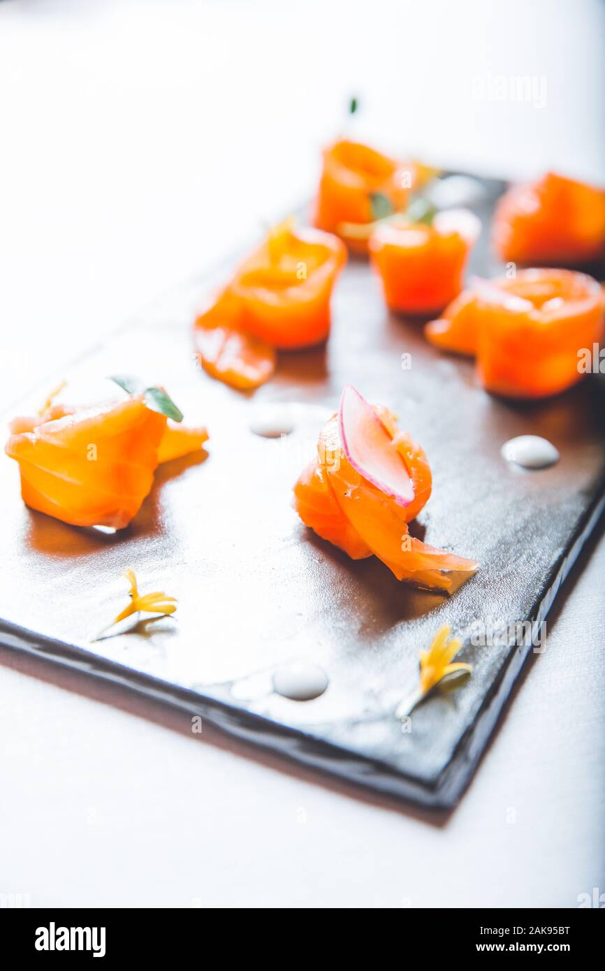Salmon Slices on black slate slabs, sushi raw fish Stock Photo - Alamy