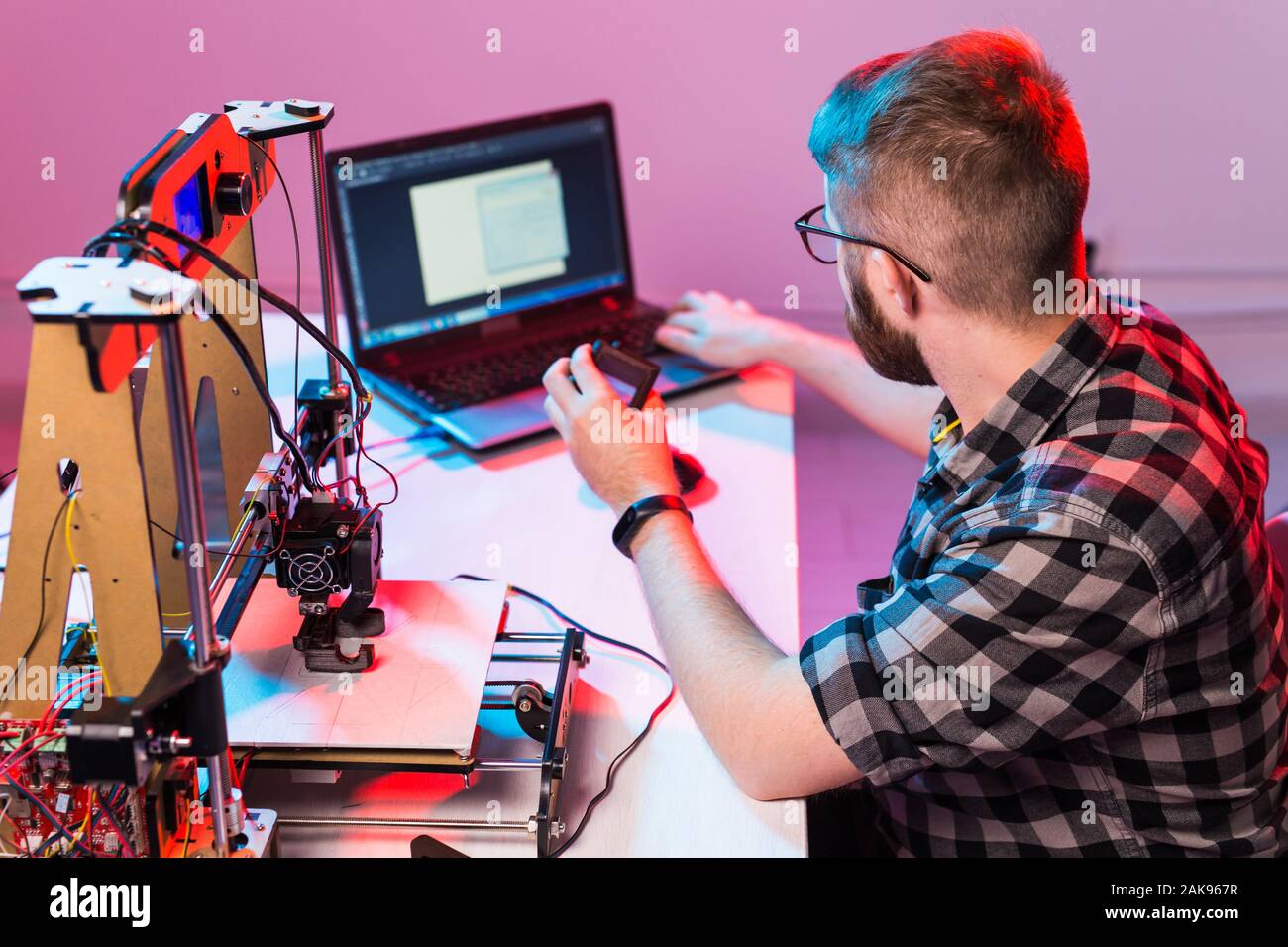A student man print prototype on 3D printer. Stock Photo