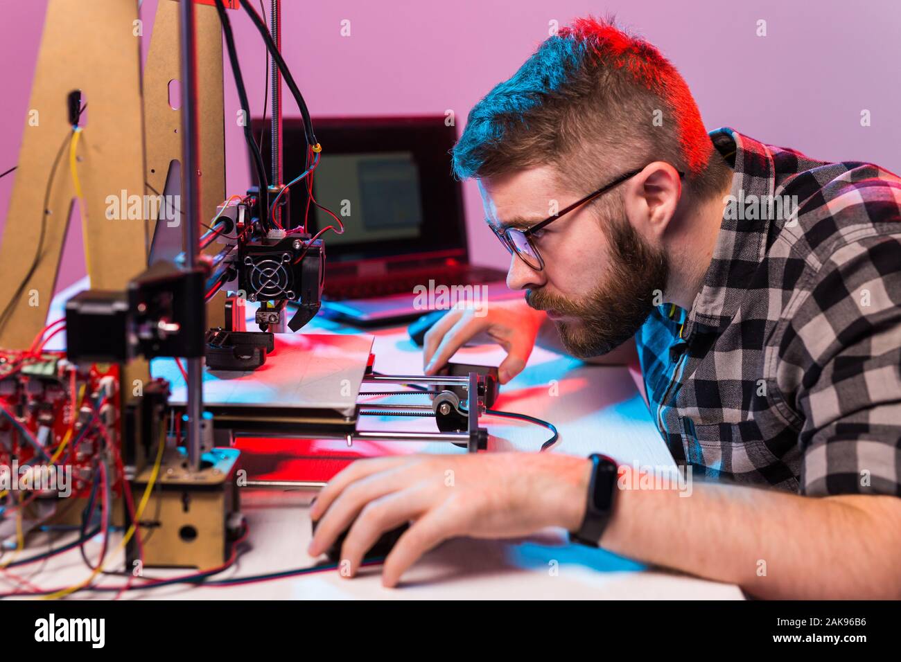 A student man print prototype on 3D printer. Stock Photo