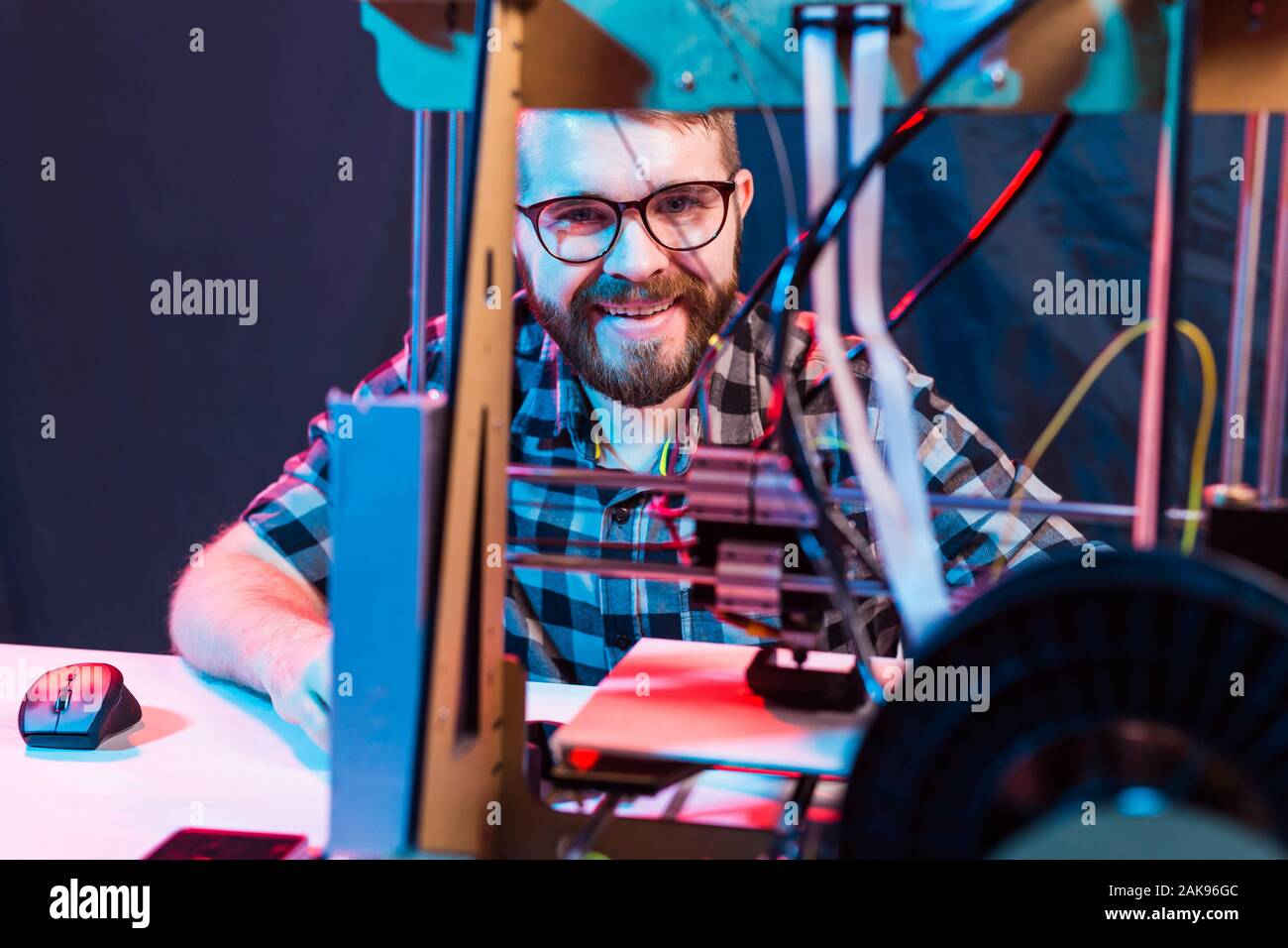 A student man print prototype on 3D printer. Stock Photo