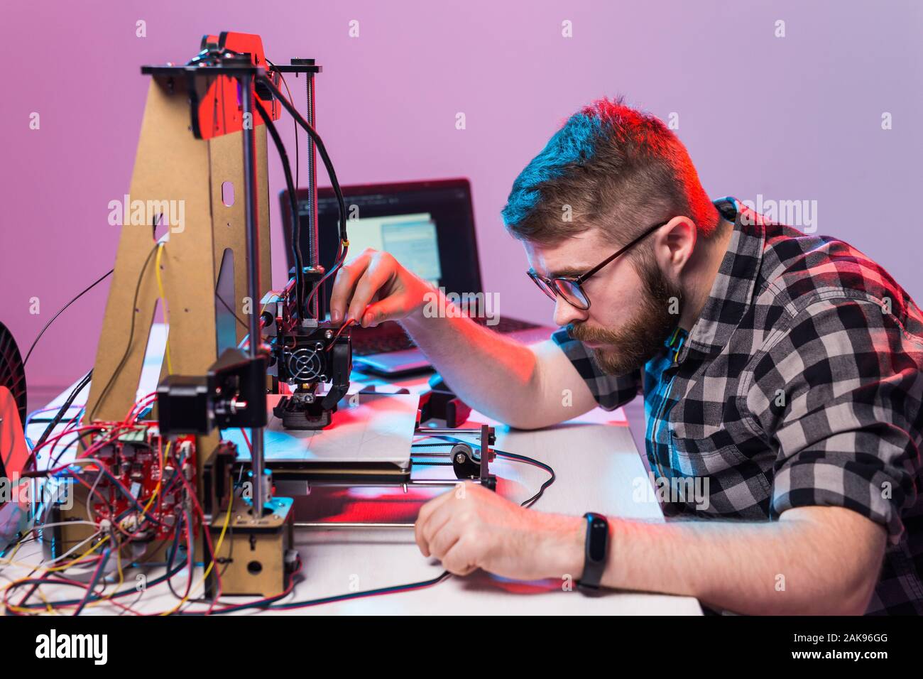 A student man print prototype on 3D printer. Stock Photo