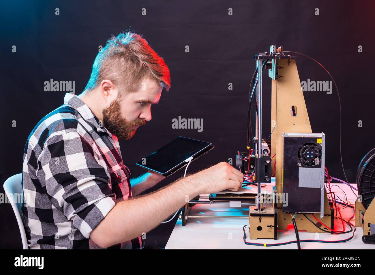 A student man print prototype on 3D printer. Stock Photo