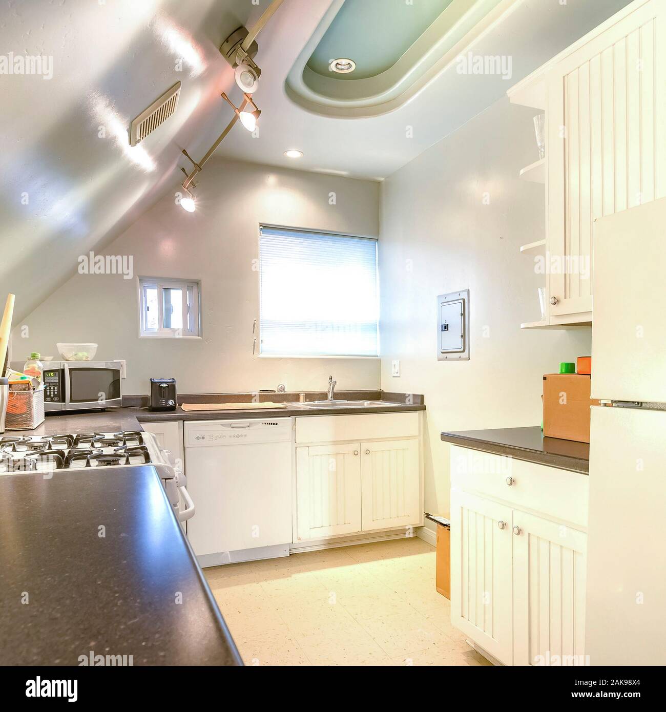 Square Bright Open And Warm Kitchen With Vaulted Ceiling And Various Utensils Stock Photo Alamy