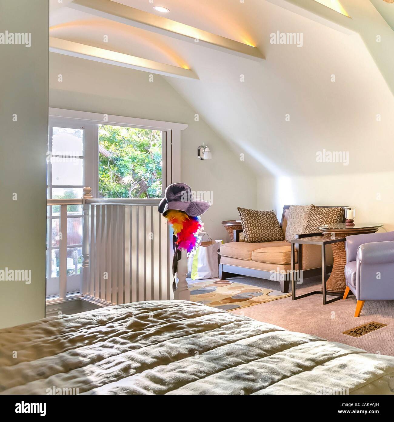 Square Frame Bright Open And Warm Living Room With Vaulted Ceilings Fan And Golden Light Pouring In From The Deck Stock Photo Alamy