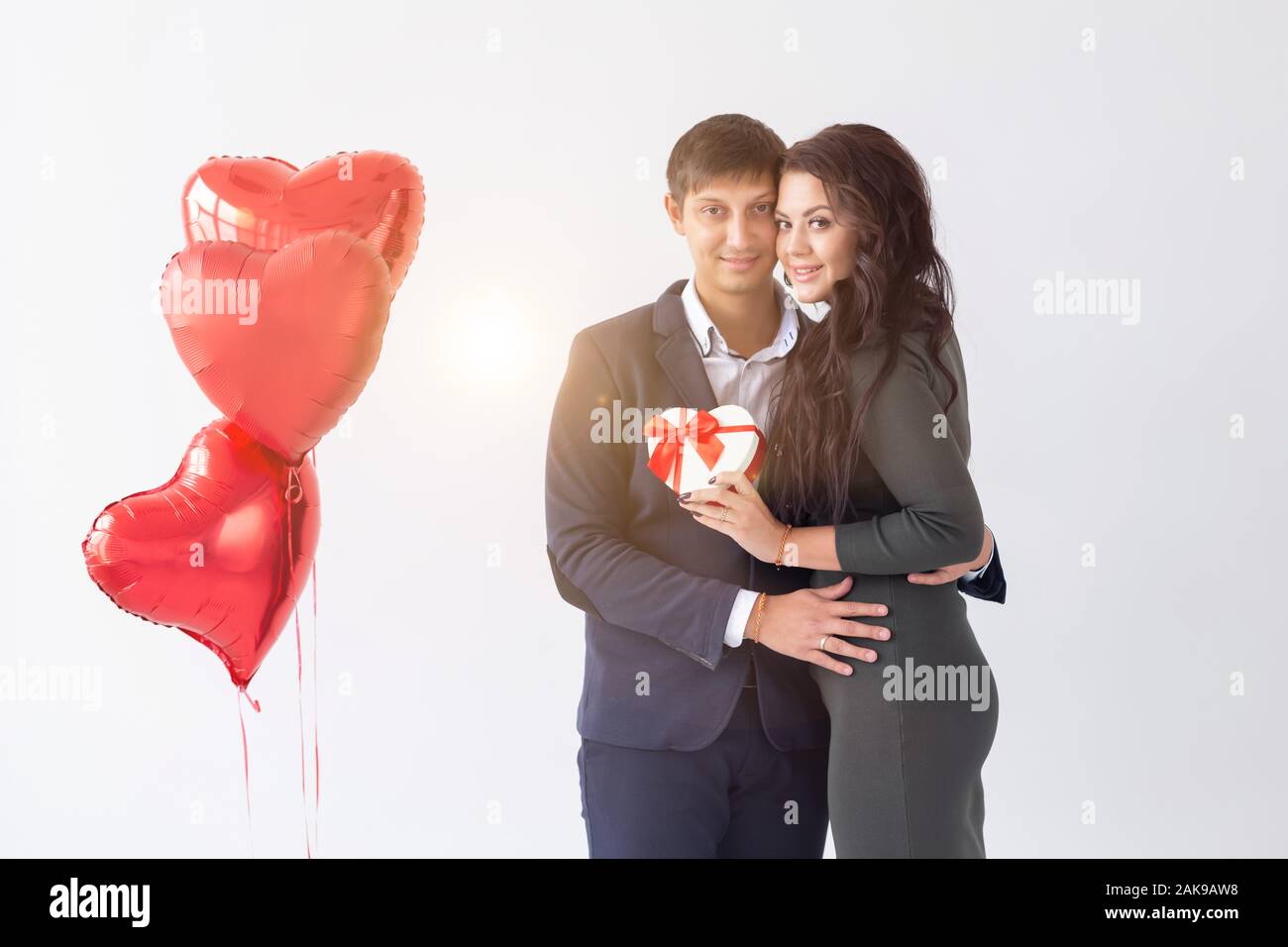 Valentine's day, holiday and gift concept. Happy young couple with ...