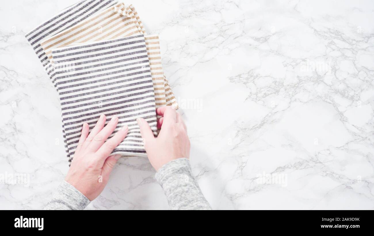 Flat lay. Folding kitchen towels on a marble countertop Stock Photo Alamy