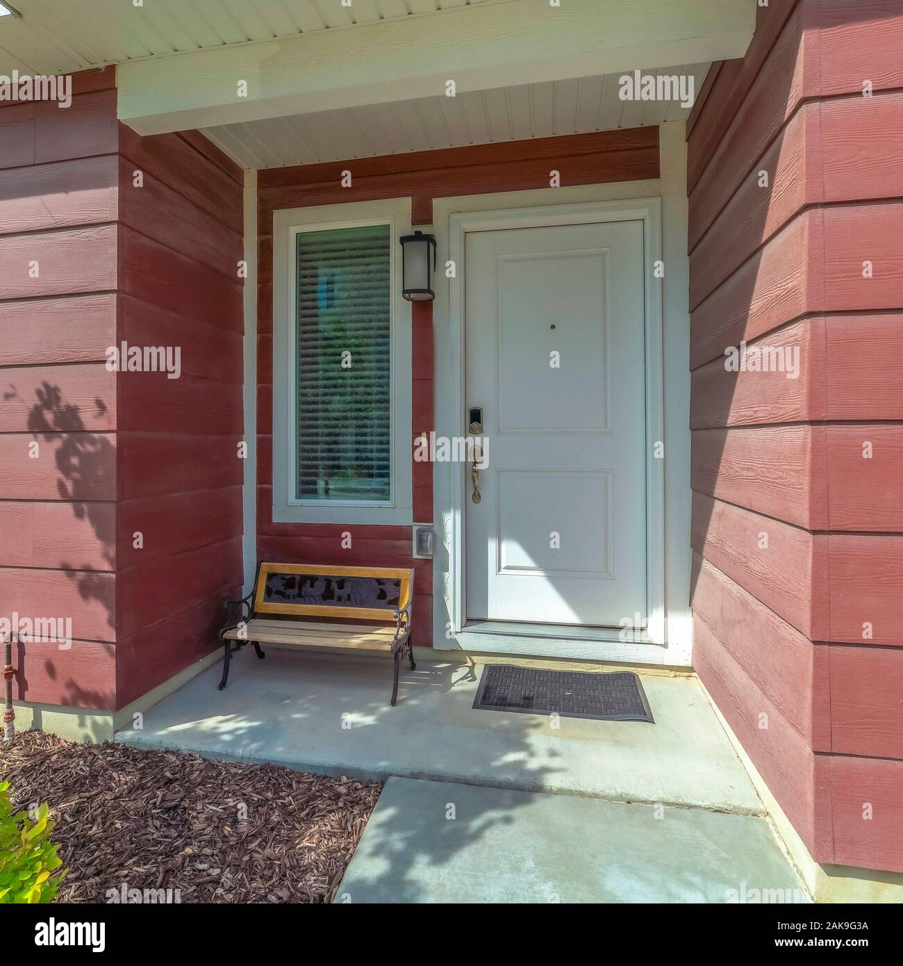 Square Frame Close Up Of Townhouse Facade With A Bench By The