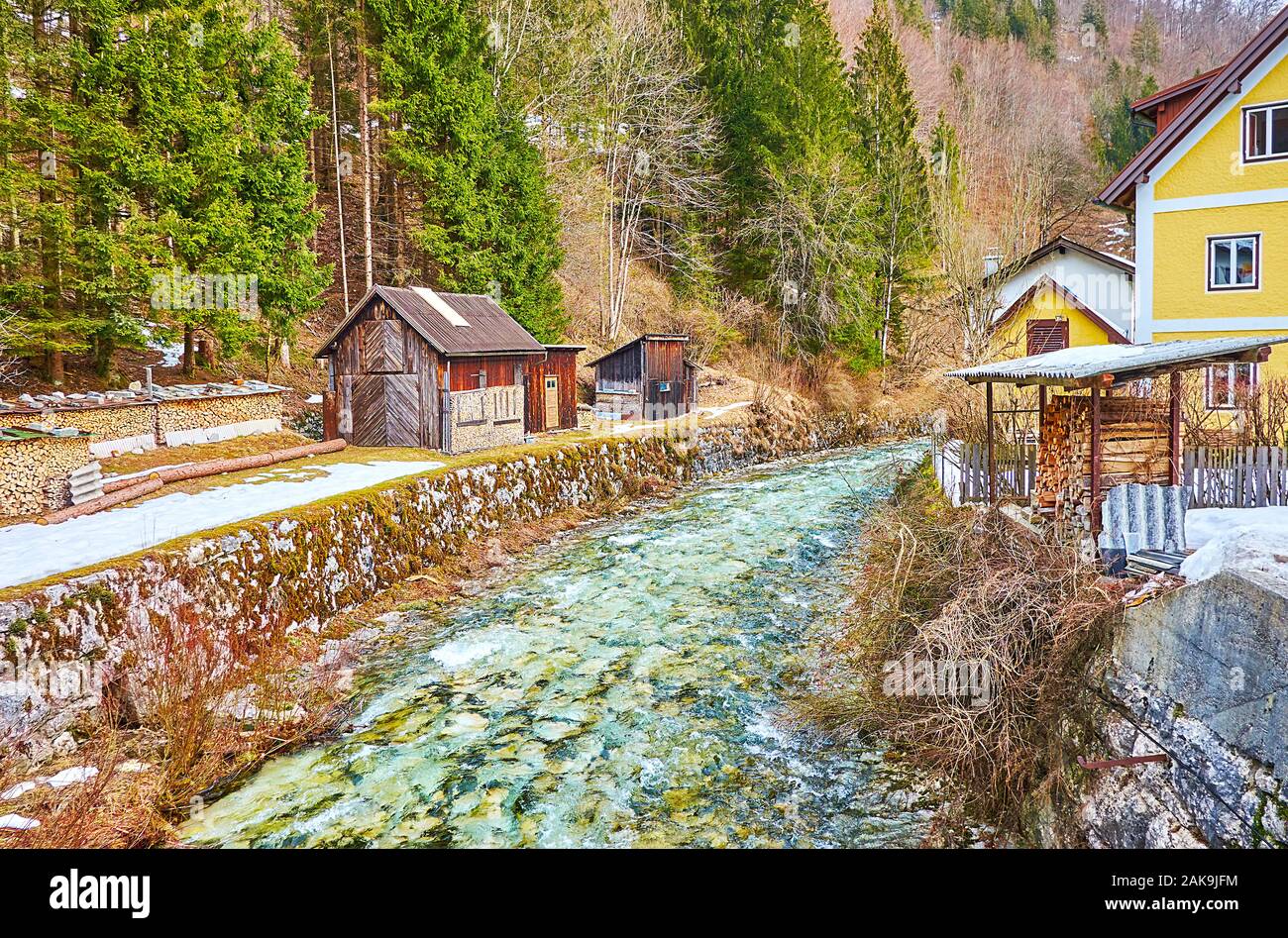 The Piles Of Firewood And Small Barns Stretch Along The Narrow