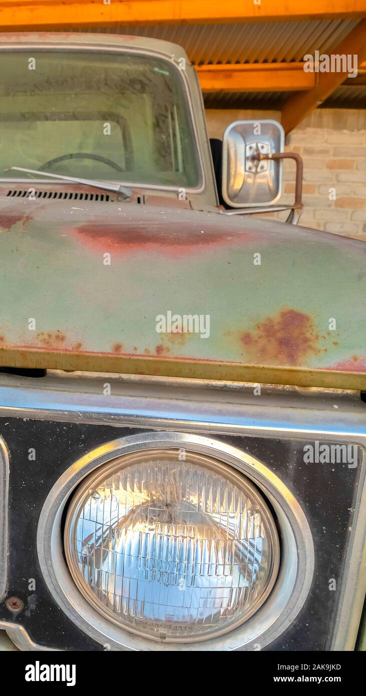 Vertical frame Front view of the dirty and rusty exterior of an old ...