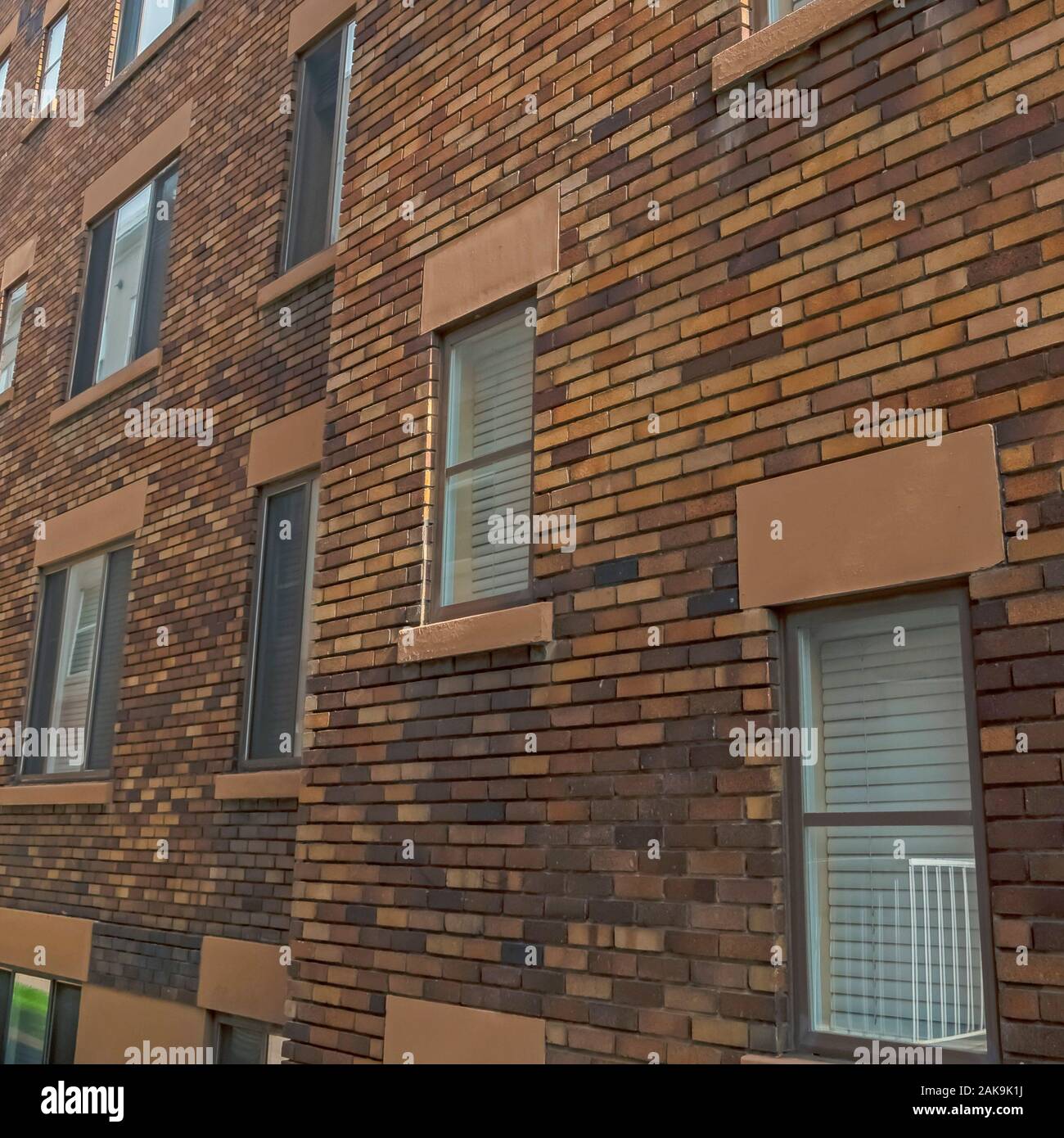 Square Exterior of an old classic building with brick wall and windows ...