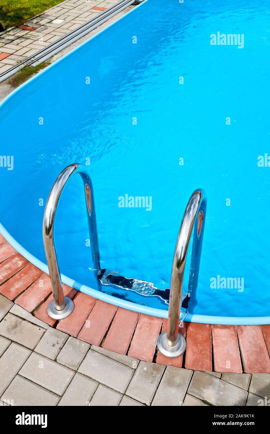 Metal swimming pool steps Stock Photo