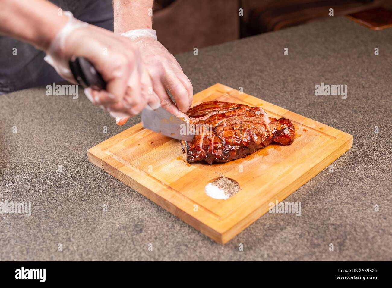 food-delicious-and-craft-concept-man-cutting-horse-meat-steak-stock