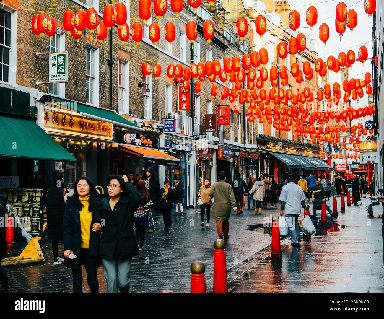London, UK/Europe; 20/12/2019: Chinatown street full of chinese red lanterns, shops, restaurants and people walking and shopping. Soho district in Lon Stock Photo
