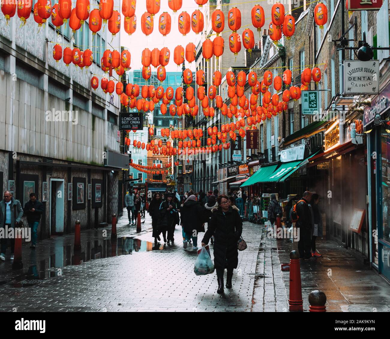 London, UK/Europe; 20/12/2019: Chinatown street full of chinese red lanterns, shops, restaurants and people walking and shopping. Soho district in Lon Stock Photo