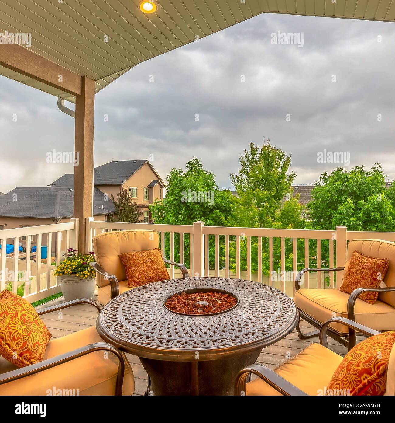Square frame Balcony with chairs around table with fire pit against