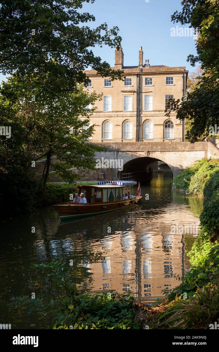 BATH, UK - OCTOBER 2, 2011: Tourists on a boat trip along the Kennet and Avon canal pass by the historic Cleveland House, once the headquarters of the Stock Photo