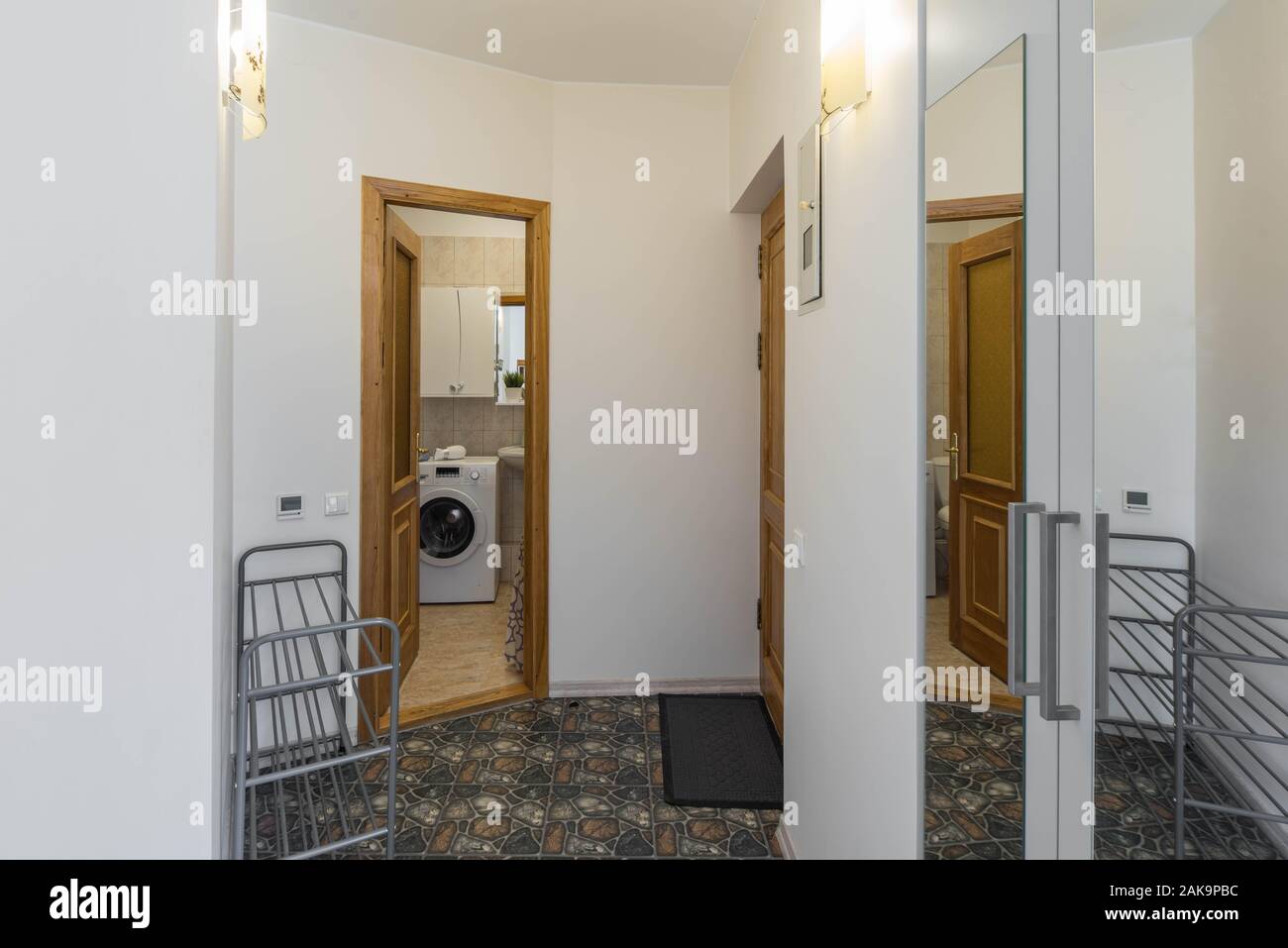 Entrance hall in the studio apartment. Opened door to the bathroom