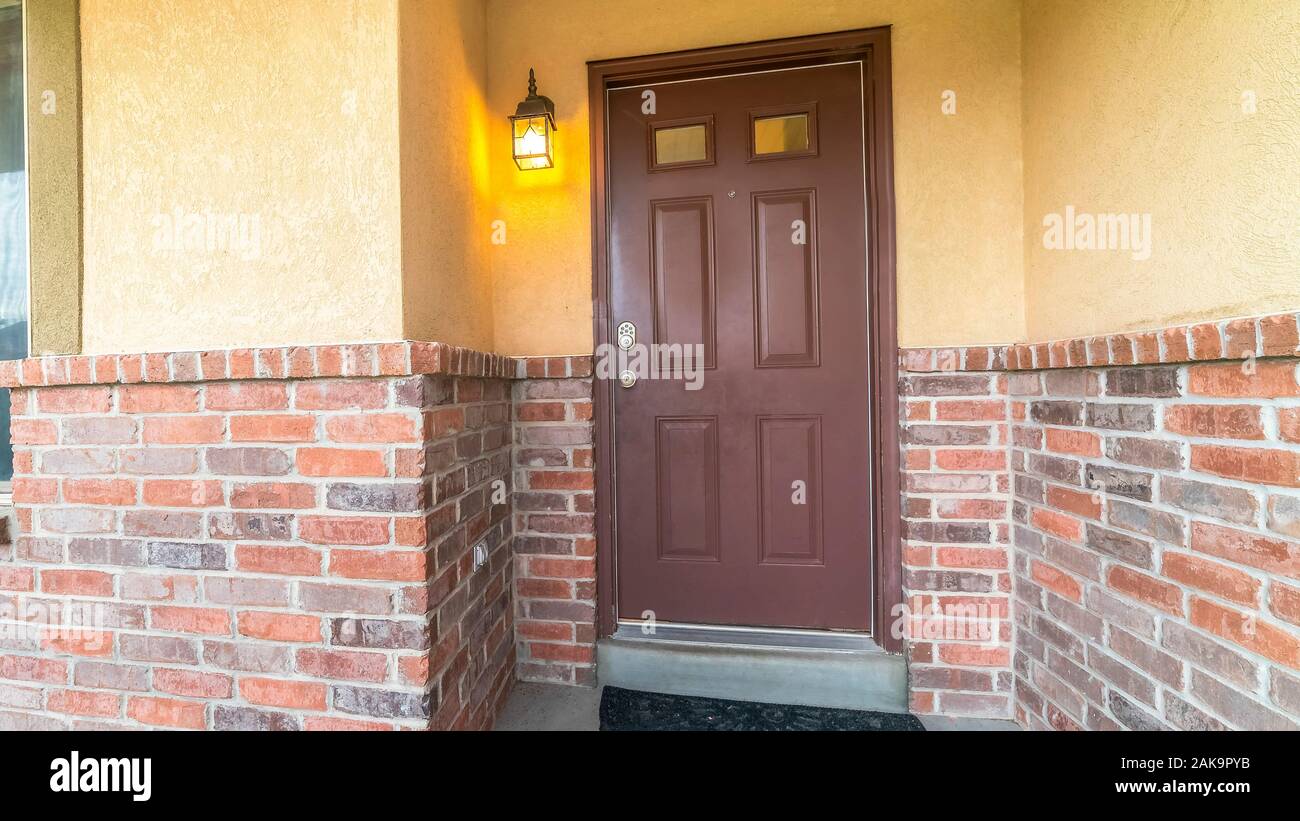 Pano frame Brown door with glass panels of a home with concrete and ...