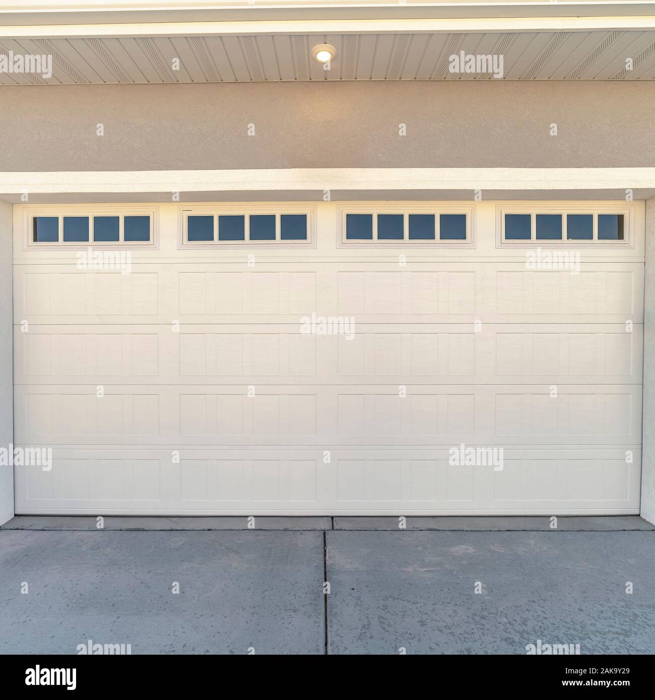 Square White Automatic Garage Door For Two Cars Stock Photo