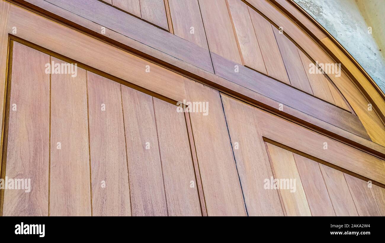 Panorama Natural wood double arched closed door exterior Stock Photo