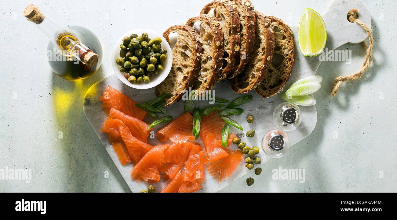 banner of rye bread with smoked salmon on a marble board. winter snack. Stock Photo
