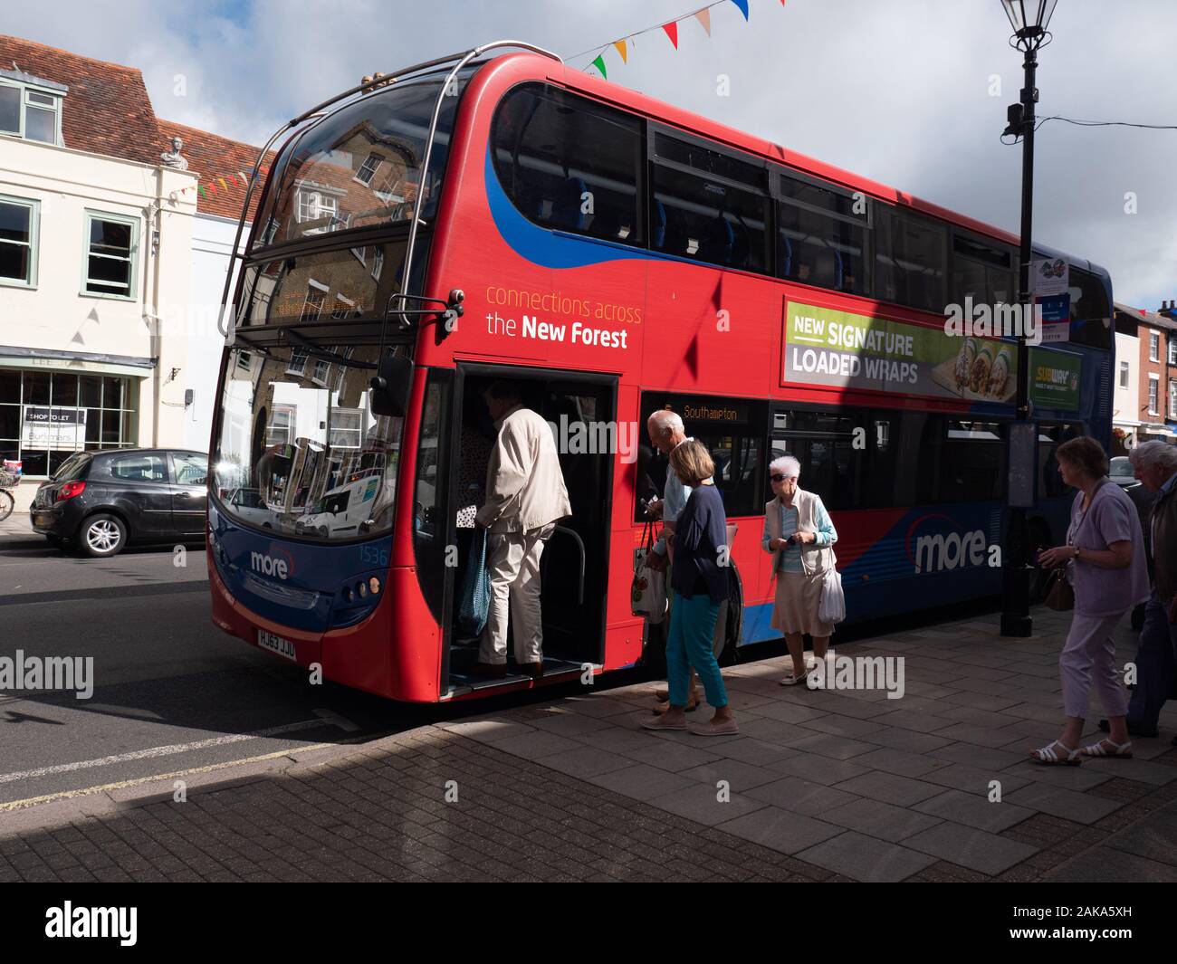 A Alexander Dennis Enviro 400 bus operated by Go South Coast, loads passengers in Lymington Stock Photo