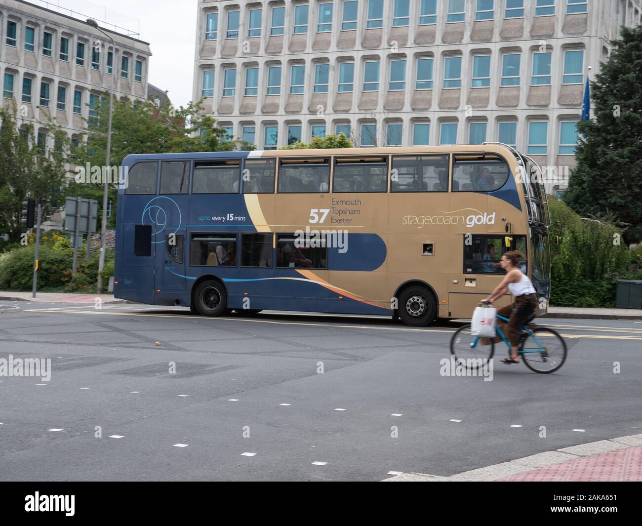 Cyclist passing a stagecoach bus in Swindon Stock Photo