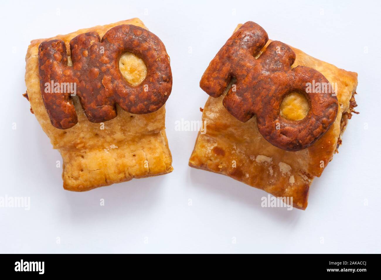 Two M&S Handcrafted Sausage Rolls isolated on white background - Ho Ho - looking down on from above Stock Photo