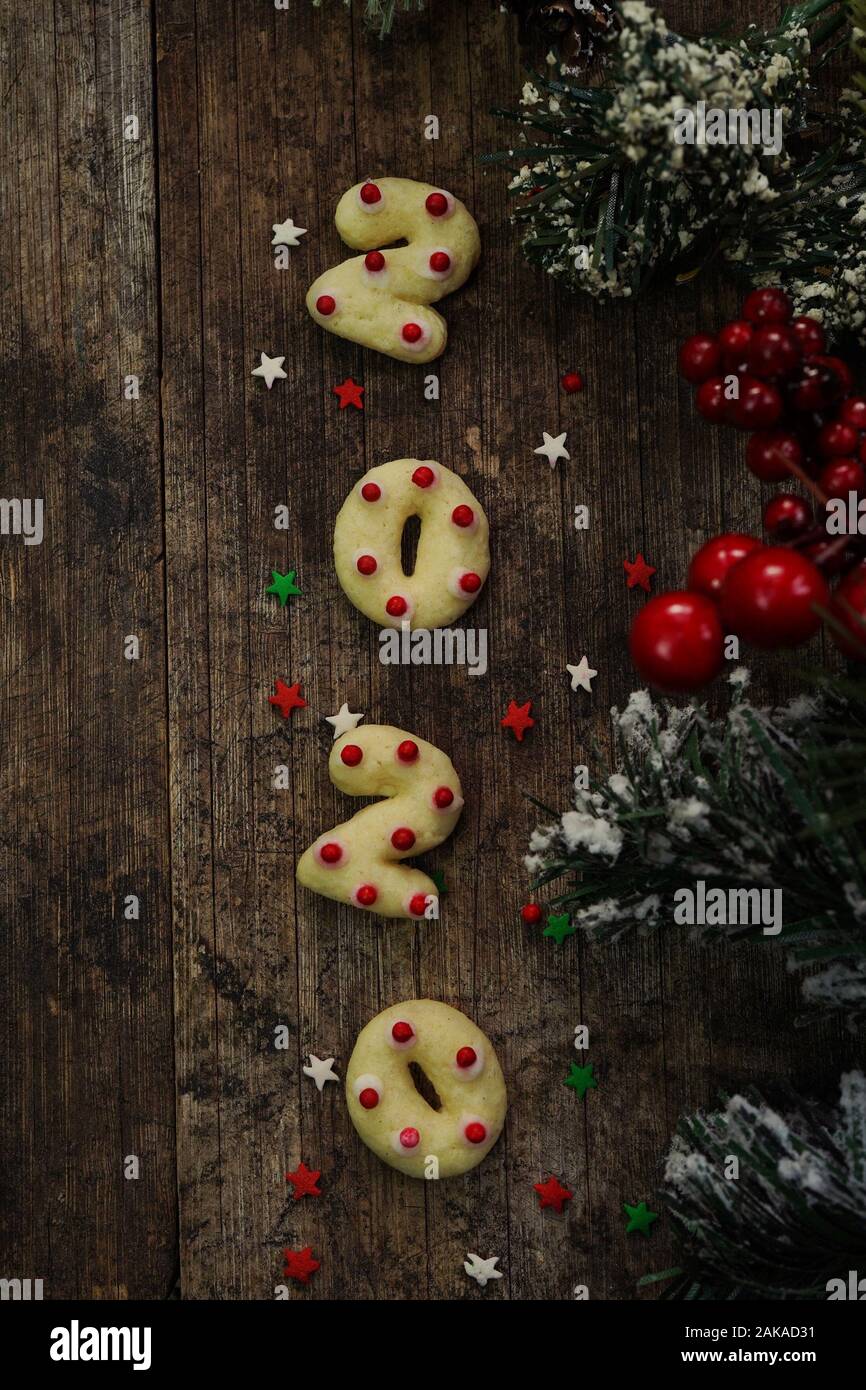2020 shaped  new year sugar cookies on rustic wooden background Stock Photo