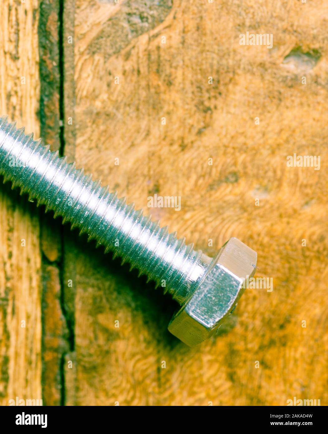 Close up of M8 bolt isolated on wooden background Stock Photo