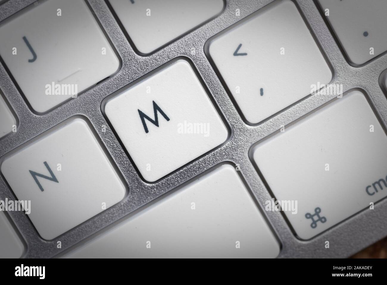 Keyboard - silver portable computer keyboard in department with letter M isolated on white button Stock Photo - Alamy