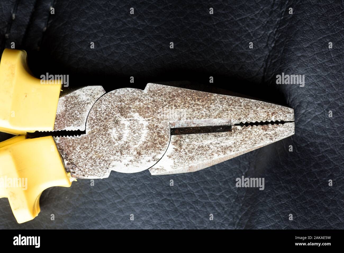 Old rusty pliers closeup on a black background Stock Photo