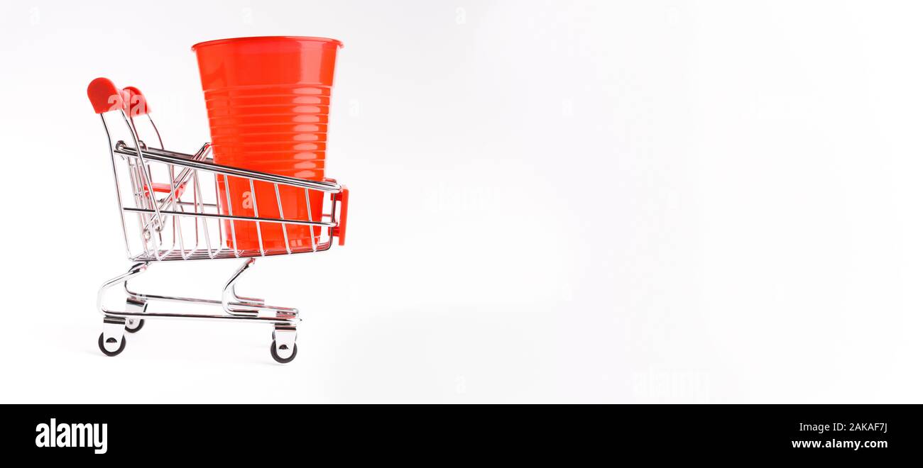 Global environment problem. Shopping cart with plastic waste isolated