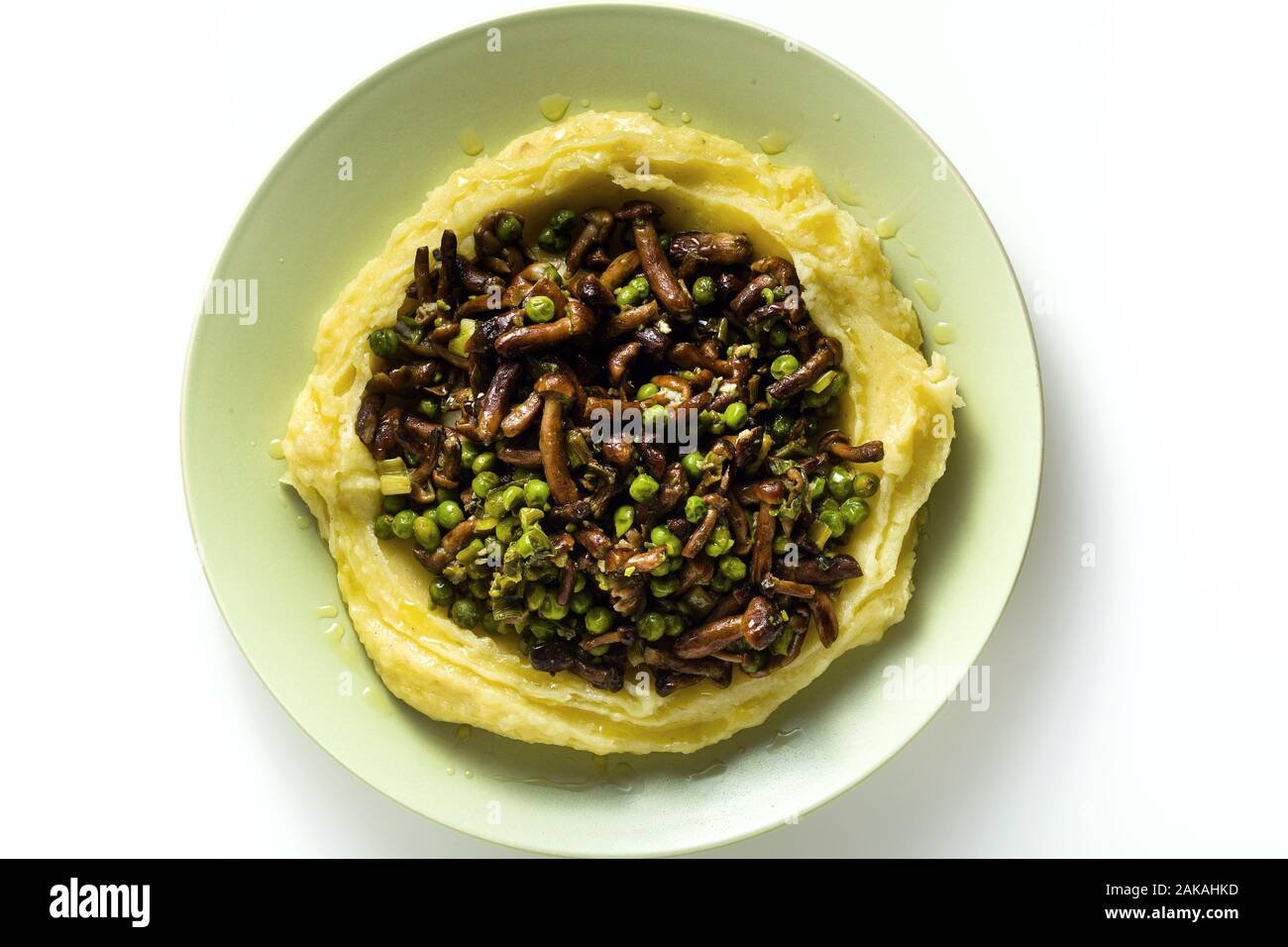 mashed potatoes with mushrooms and green peas on the table. healthy spring food Stock Photo