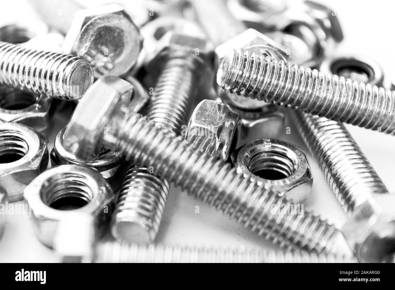 Metal bolts and nuts in a row background. Chromed screw bolts and nuts