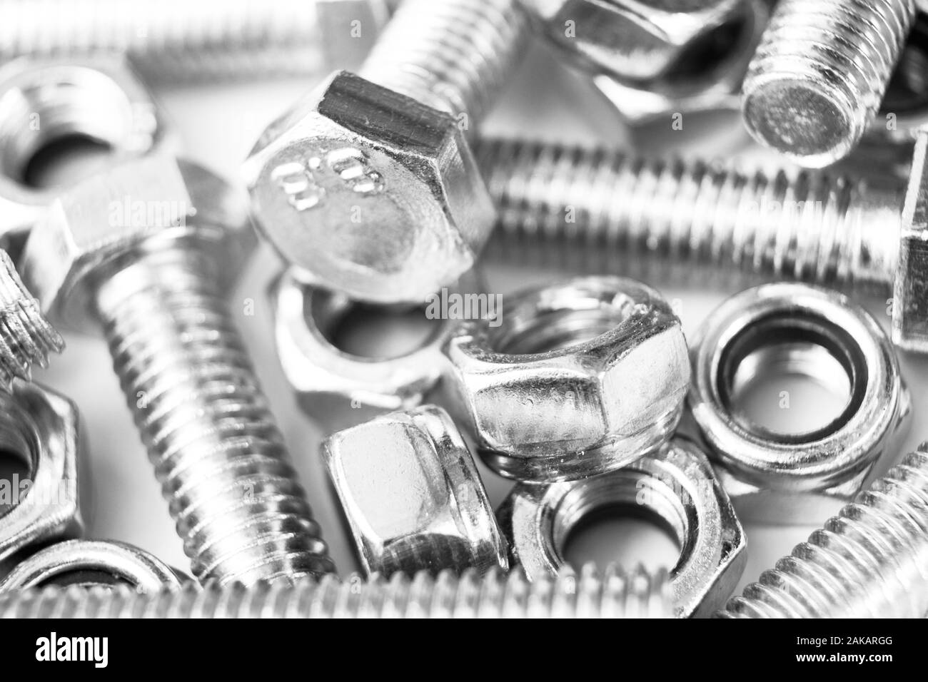 Metal bolts and nuts in a row background. Chromed screw bolts and nuts