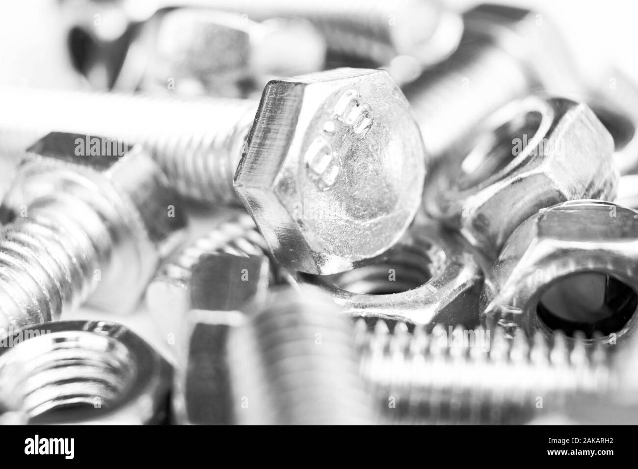 Metal bolts and nuts in a row background. Chromed screw bolts and nuts isolated. Steel bolts and