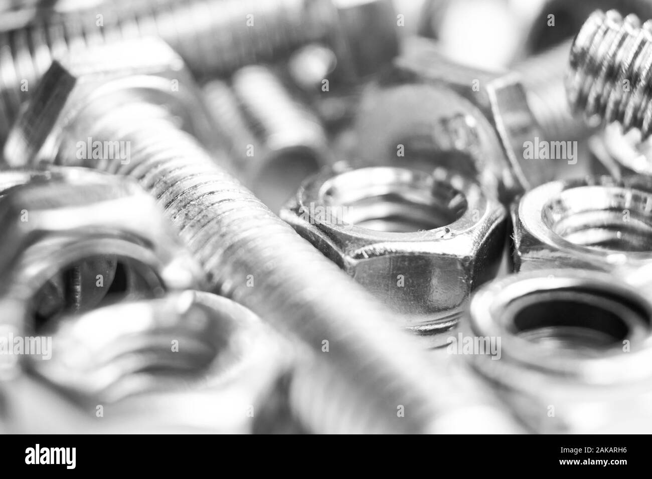 Metal bolts and nuts in a row background. Chromed screw bolts and nuts isolated. Steel bolts and