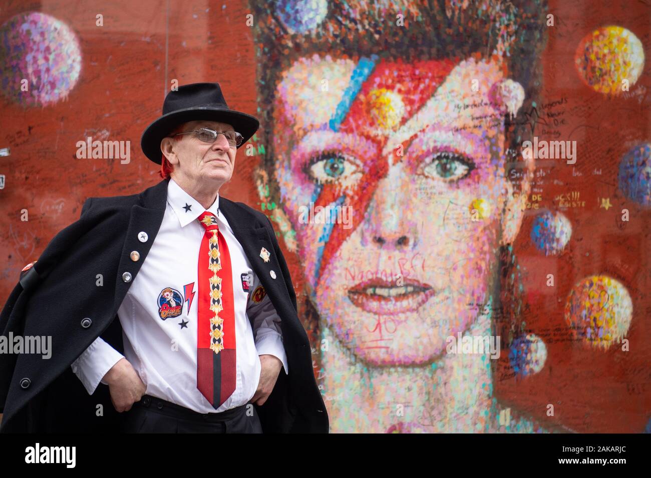 David Bowie fan Clive Daly at the David Bowie mural in Brixton, south London, on what would have been the singer's 73rd birthday. Stock Photo