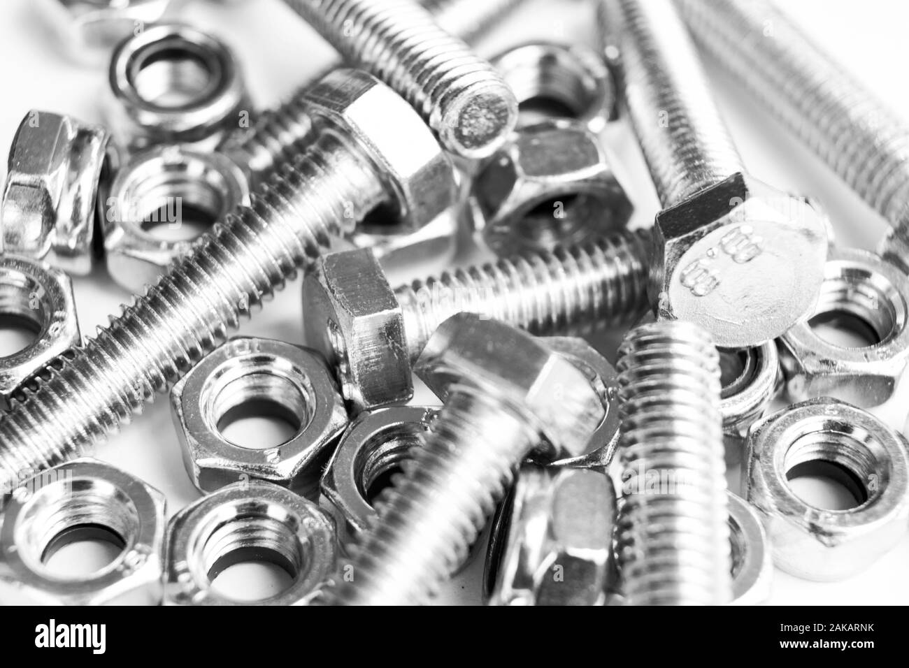 Metal bolts and nuts in a row background. Chromed screw bolts and nuts