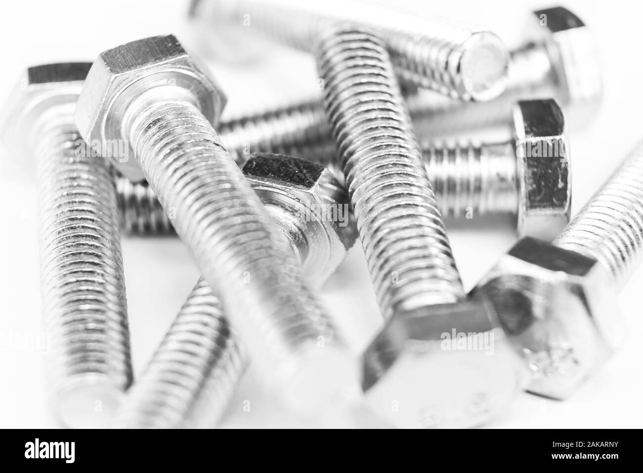 Metal bolts in a row background. Chromed screw bolts isolated. Steel