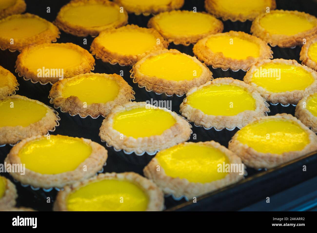 egg tarts on metal plate, sweet dessert in bakery Stock Photo